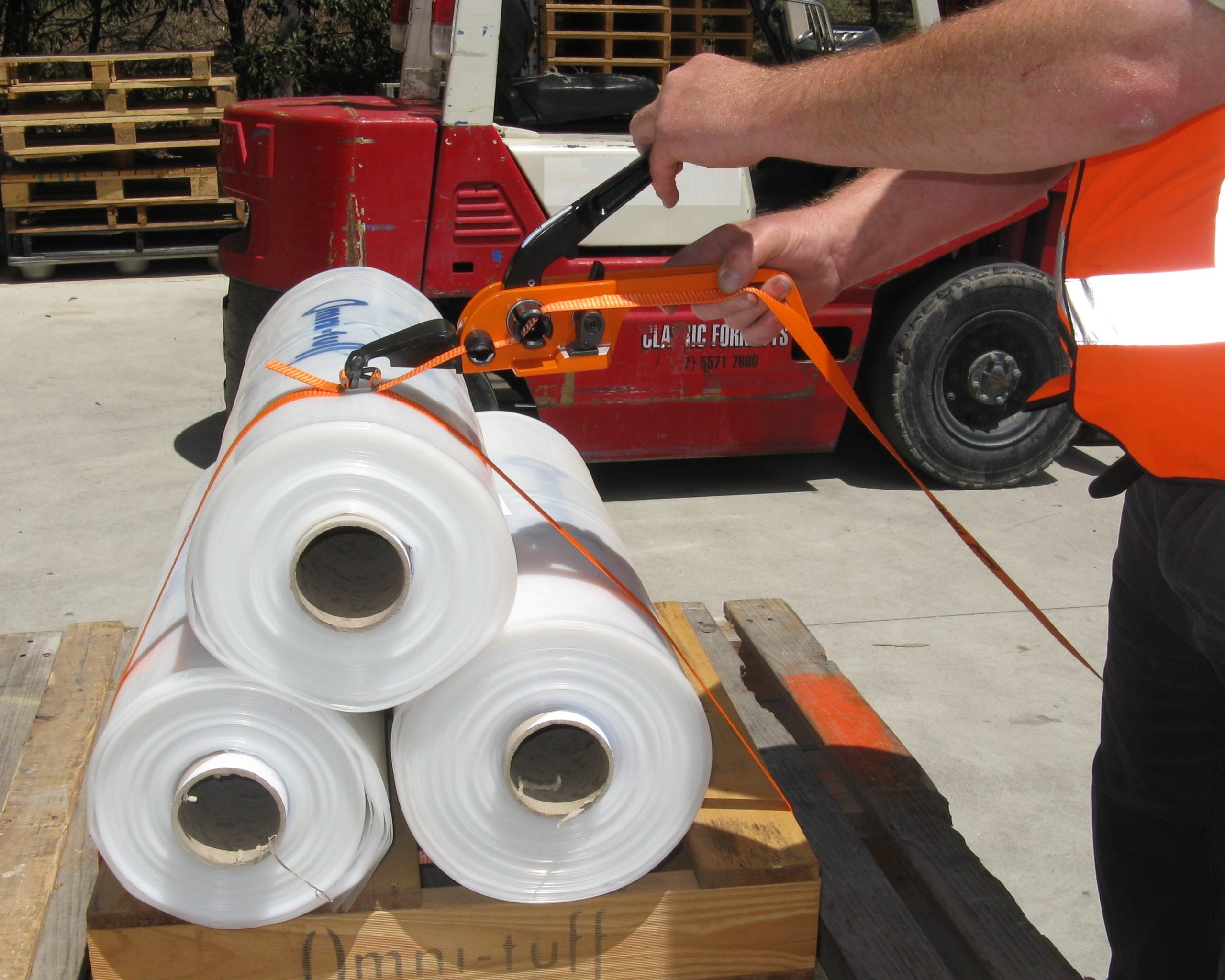 a man strapping items with poly strap