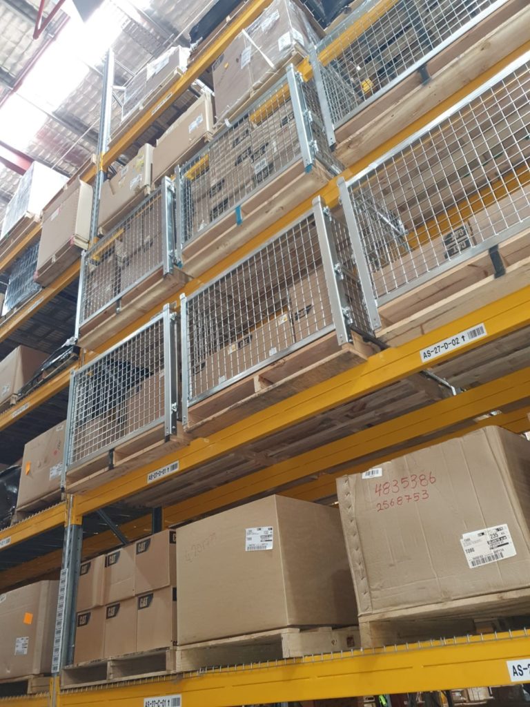 rows of metal cages and boxes in warehouse