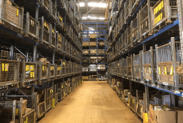 aisle of stacked steel cages