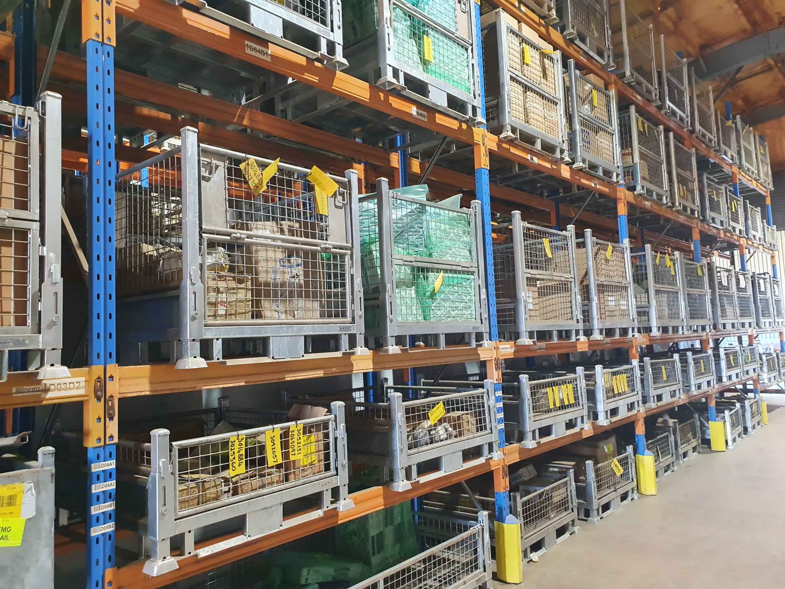 components stored in steel pallet cages