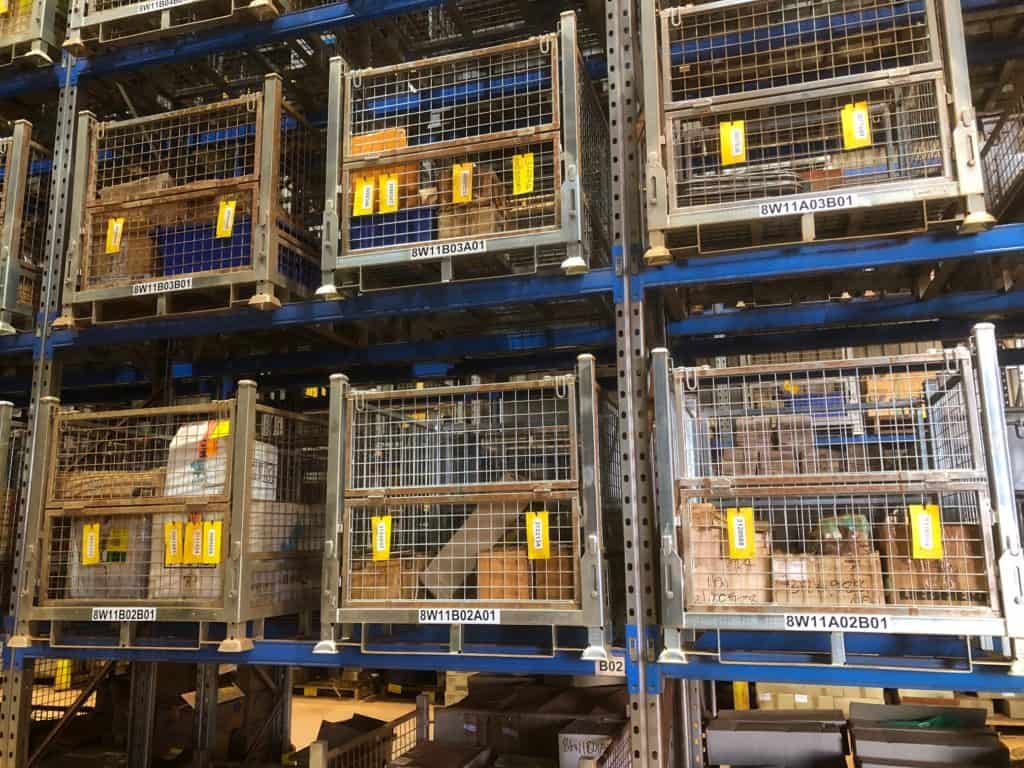 components stored in steel pallet cages