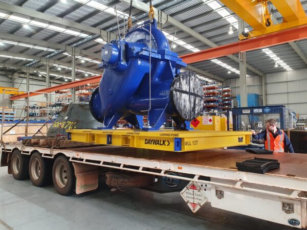 Large machinery component being secured on a truck