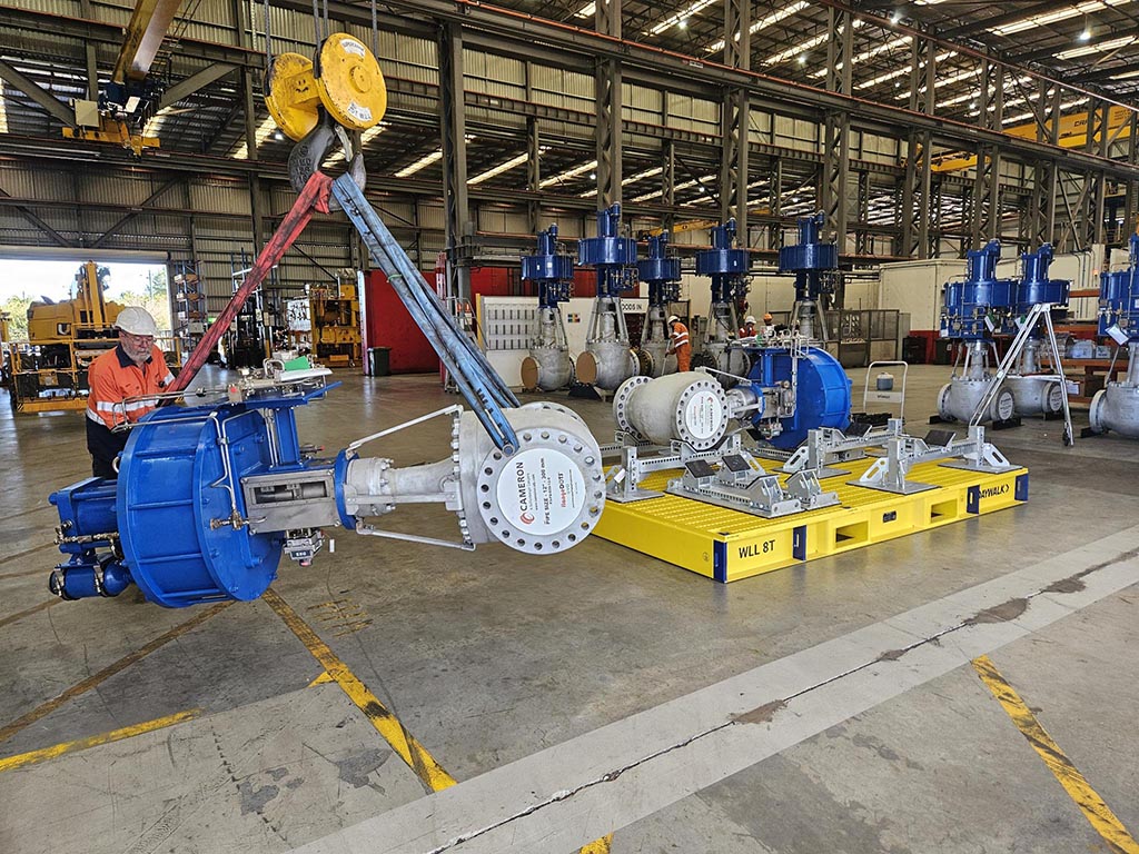 large machinery component being lifted with a crane.