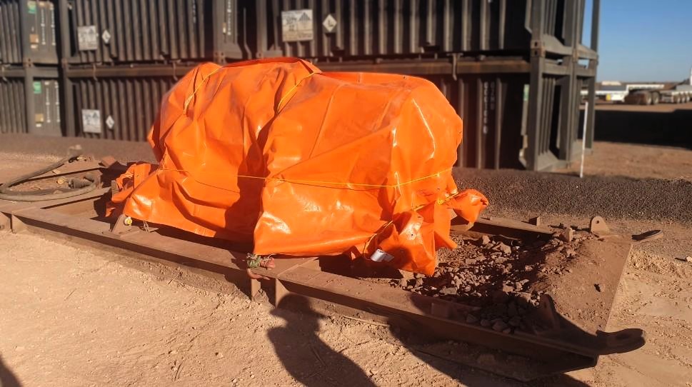 Large component with orange cover on failing frame on mining site