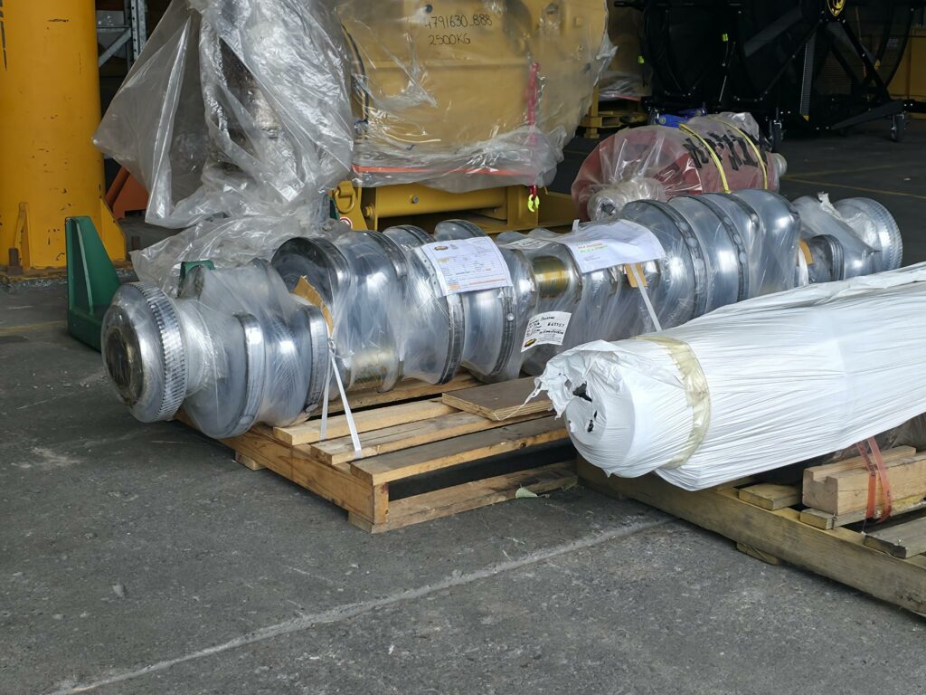 case study image of cylindrical components on wood crates