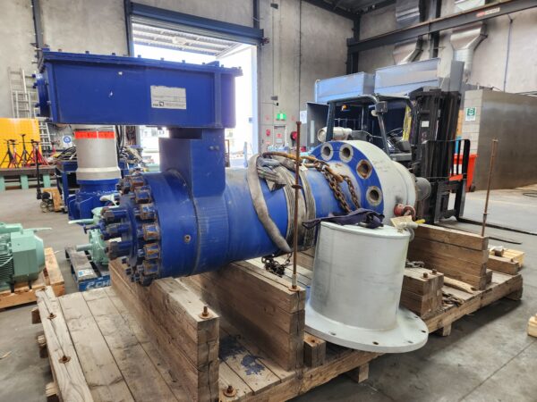 Pump for mining operations on wooden broken pallet.