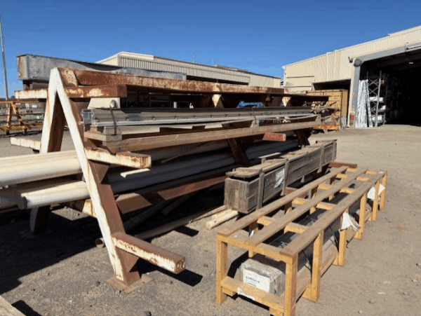 Old racking at a mine site, with various long items stored.